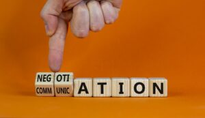 Negotiation is communication spelled with wooden cubes