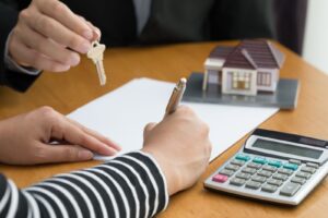A person signing a document for a home loan