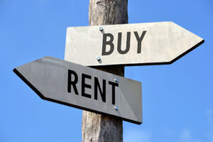 Road signs with the words “rent” and “buy” on them
